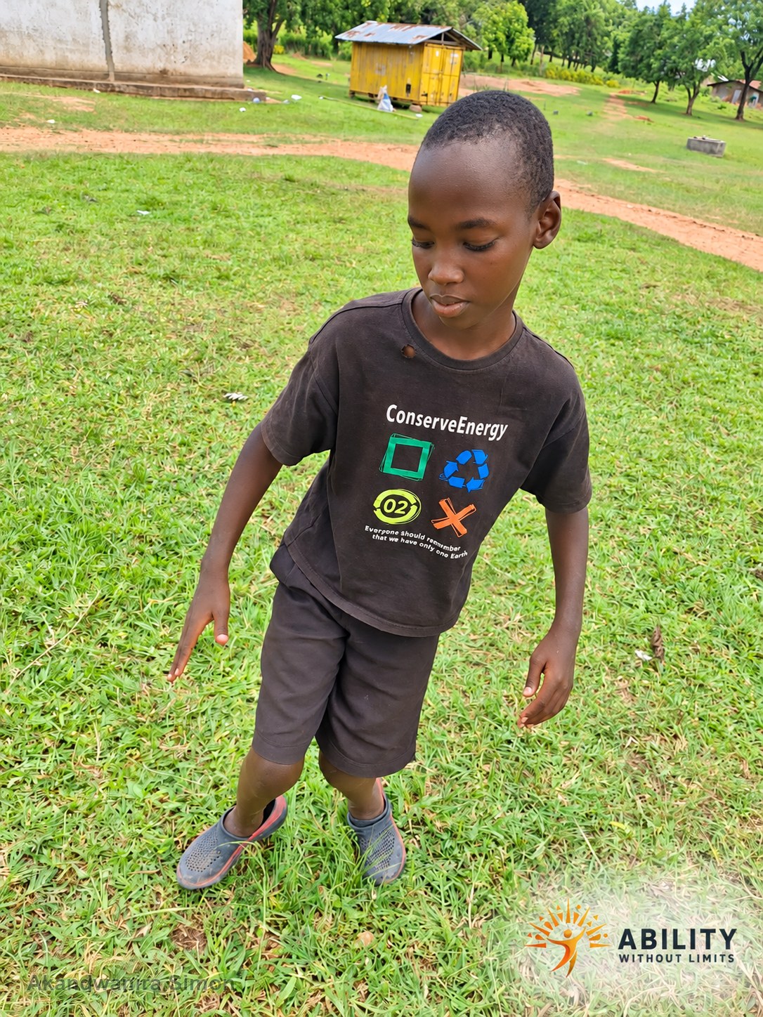Akandwanira Simon standing on grass outdoors